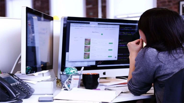 Interfaz de software AGM Planillas ejecutándose en monitores de oficina